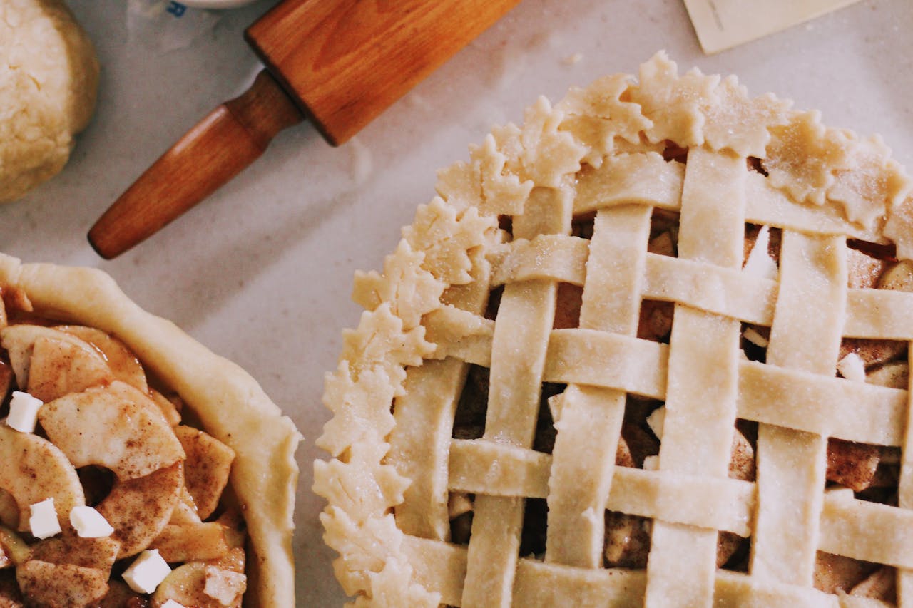 Delicious homemade apple pie with lattice crust in a cozy baking setting.
